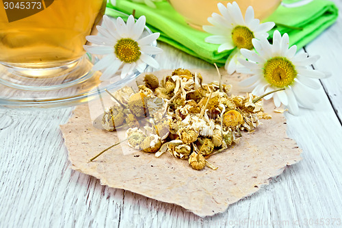 Image of Chamomile dried on paper with glass cup