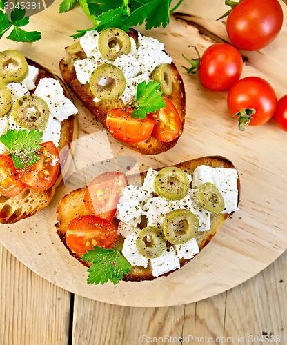 Image of Sandwich with feta and olives on table