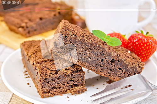 Image of Pie chocolate with strawberries in plate on napkin