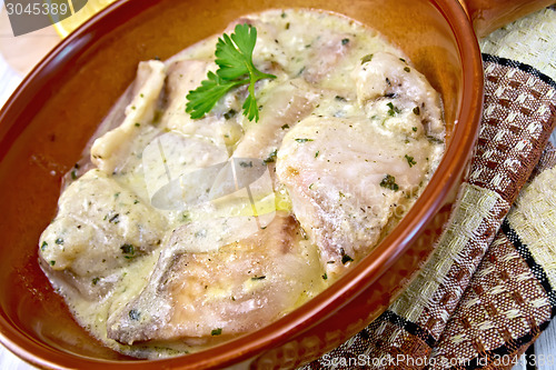 Image of Fish stew in creamy sauce on ceramic pan