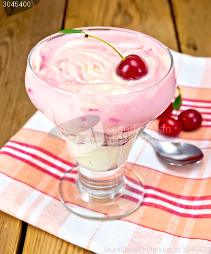 Image of Dessert milk with cherry and spoon on board