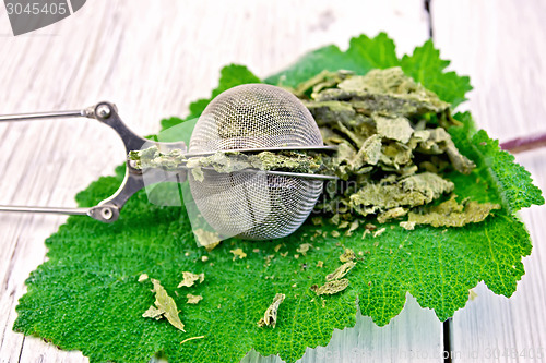 Image of Sage dried in strainer on board