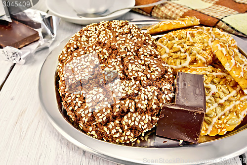 Image of Cookies chocolate and shortbread with sesame on metal tray