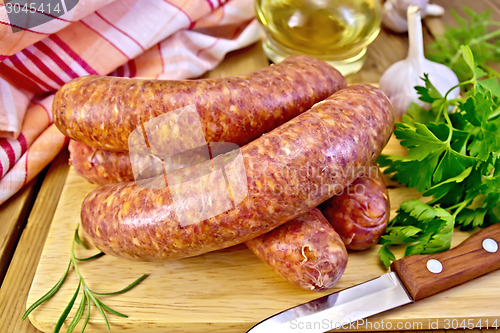 Image of Sausages beef on board with knife