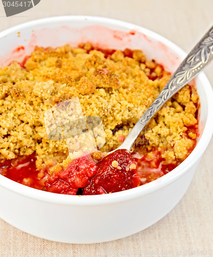 Image of Crumble strawberry with spoon on fabric