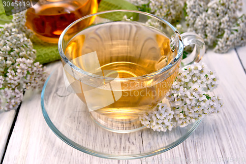 Image of Tea with yarrow in glass cup on light board