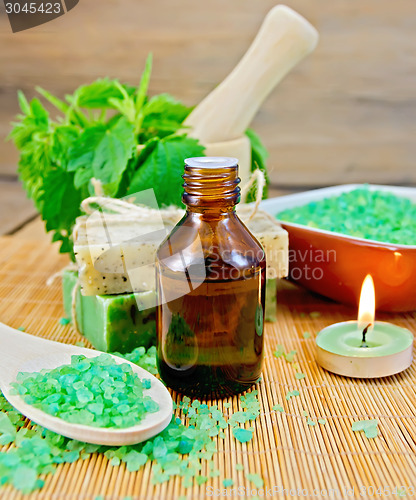 Image of Oil and salt with nettles in mortar on board