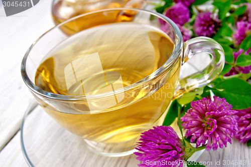 Image of Tea with clover in cup on light board