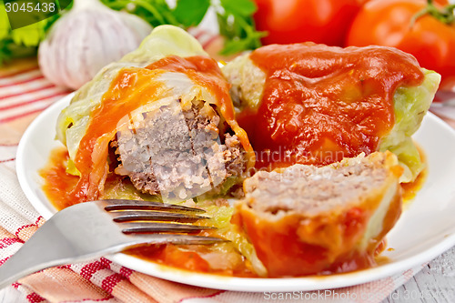 Image of Cabbage stuffed with tomato sauce on light board