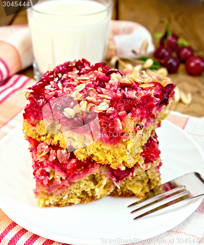Image of Pie cherry in plate with milk on board