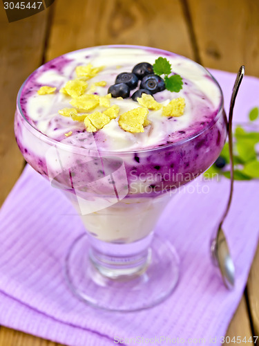 Image of Dessert milk with blueberries on purple napkin