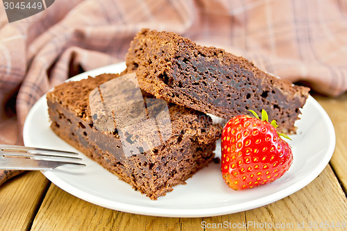 Image of Pie chocolate with strawberries in plate on board