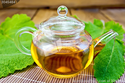 Image of Tea in teapot with sage on bamboo napkin