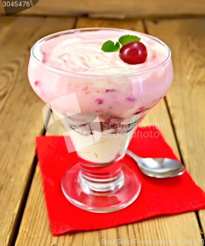 Image of Dessert milk with cherry on red napkin