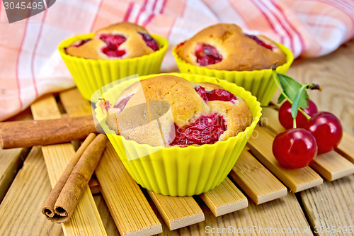 Image of Cupcakes with cherries in tins on board