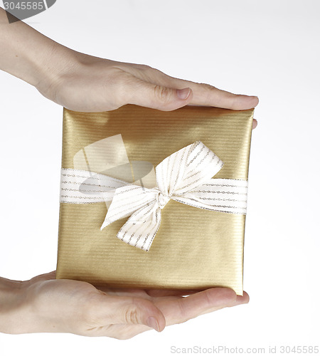 Image of Young woman holding a present