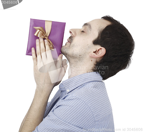 Image of Young man holding a present