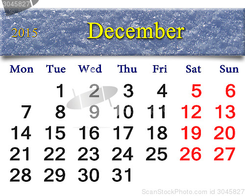 Image of calendar for December of 2015 with layer of snow