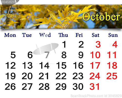 Image of calendar for October of 2015 with yellow leaves