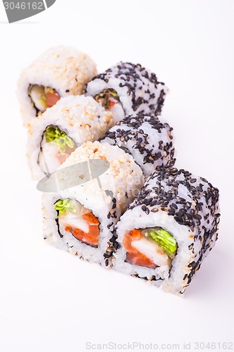 Image of salmon sushi roll in sesame seeds 