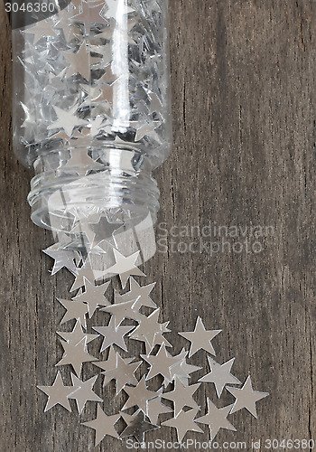 Image of silver stars for christmas on a old wooden background