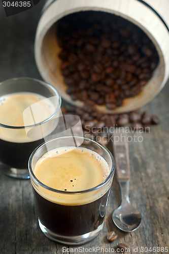 Image of two cups of coffee and coffee beans