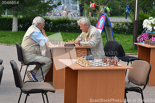 Image of Chess tournament on the street in the summer.