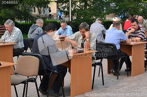 Image of Chess tournament on the street in the summer.