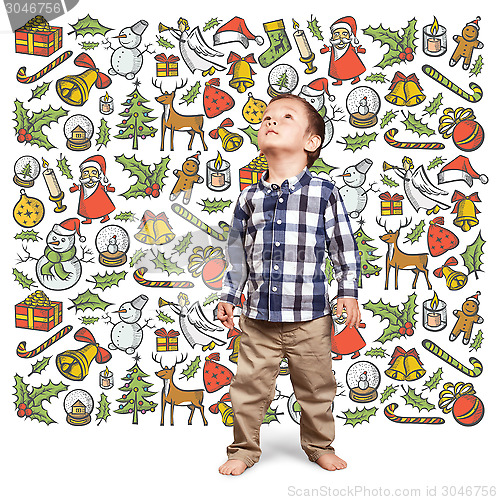 Image of Little Boy Looking For Christmas Gifts