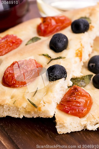 Image of Focaccia with black olives, tomatoes and basil