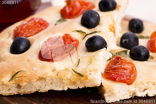 Image of Focaccia with black olives, tomatoes and basil