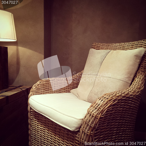 Image of Classic rattan armchair and cozy lamp