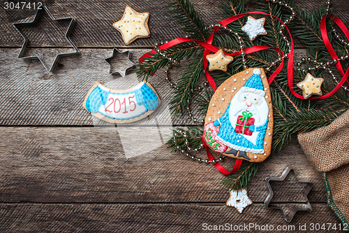 Image of Cute Santa and New Year star cookies in rustic style on wood