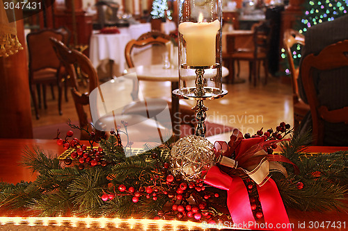 Image of Christmas decoration with burning candle