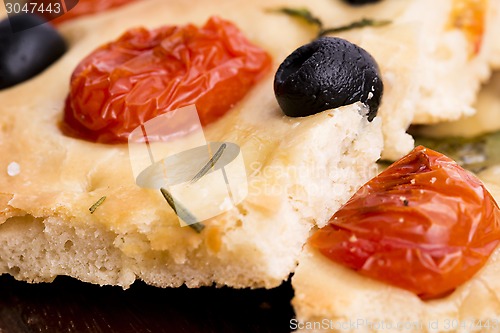 Image of Focaccia with black olives, tomatoes and basil