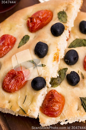 Image of Focaccia with black olives, tomatoes and basil