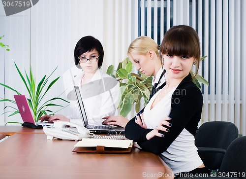 Image of Young pretty business ladies in office