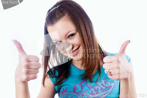 Image of Attractive girl showing thumb up gesture