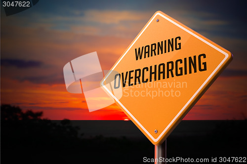 Image of Overcharging on Warning Road Sign.