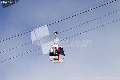 Image of Gondola lift with ski and snowboards