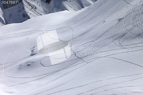 Image of Top view on snowy off piste slope with trace from ski and snowbo