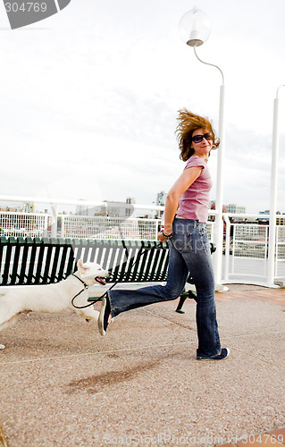 Image of woman running with dog