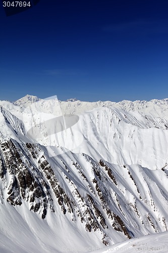 Image of Snowy rocks in sun day