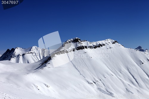 Image of Off-piste slope in sun day and traces of avalanches