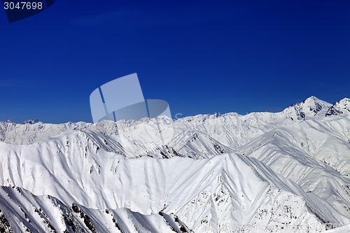 Image of Snowy winter mountains in sun day