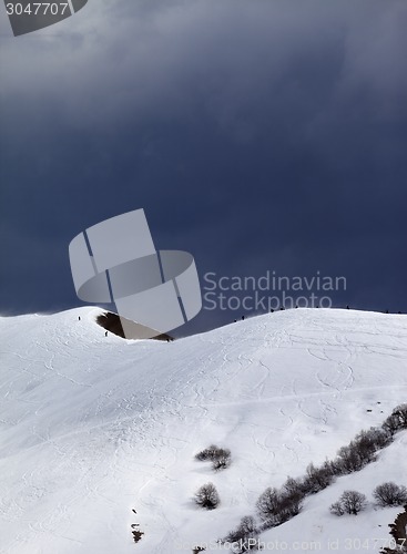 Image of Off-piste slope and overcast gray sky in windy day