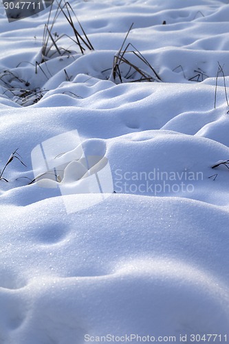 Image of Snow drifts in snowbound winter meadow 