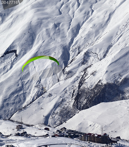 Image of Speed flying in mountains at sun day