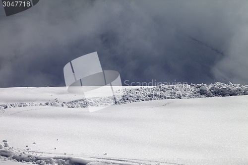 Image of Sunlight off-piste slope and mountains in mist