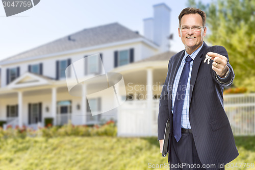 Image of Real Estate Agent with House Keys in Front of Home